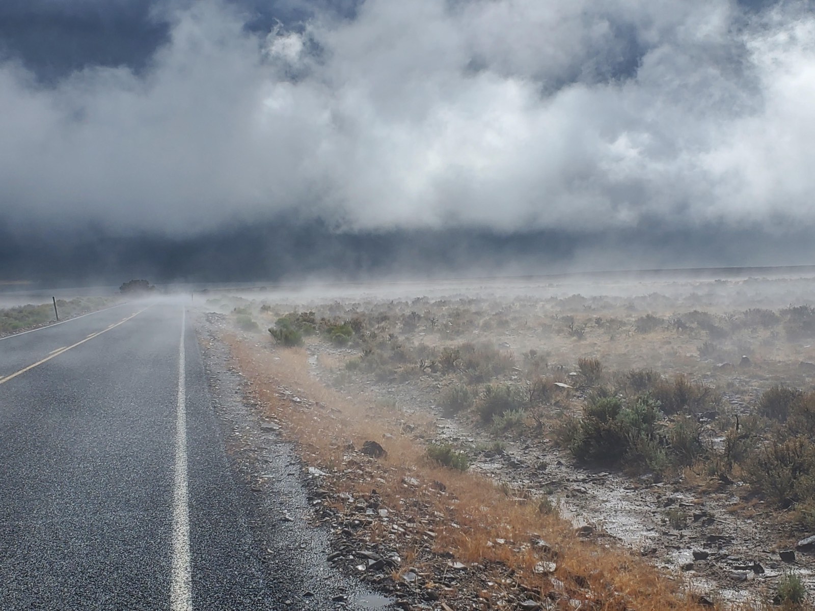 A storm front rolling over a high desert road, photo by Michael Fitzsimmons