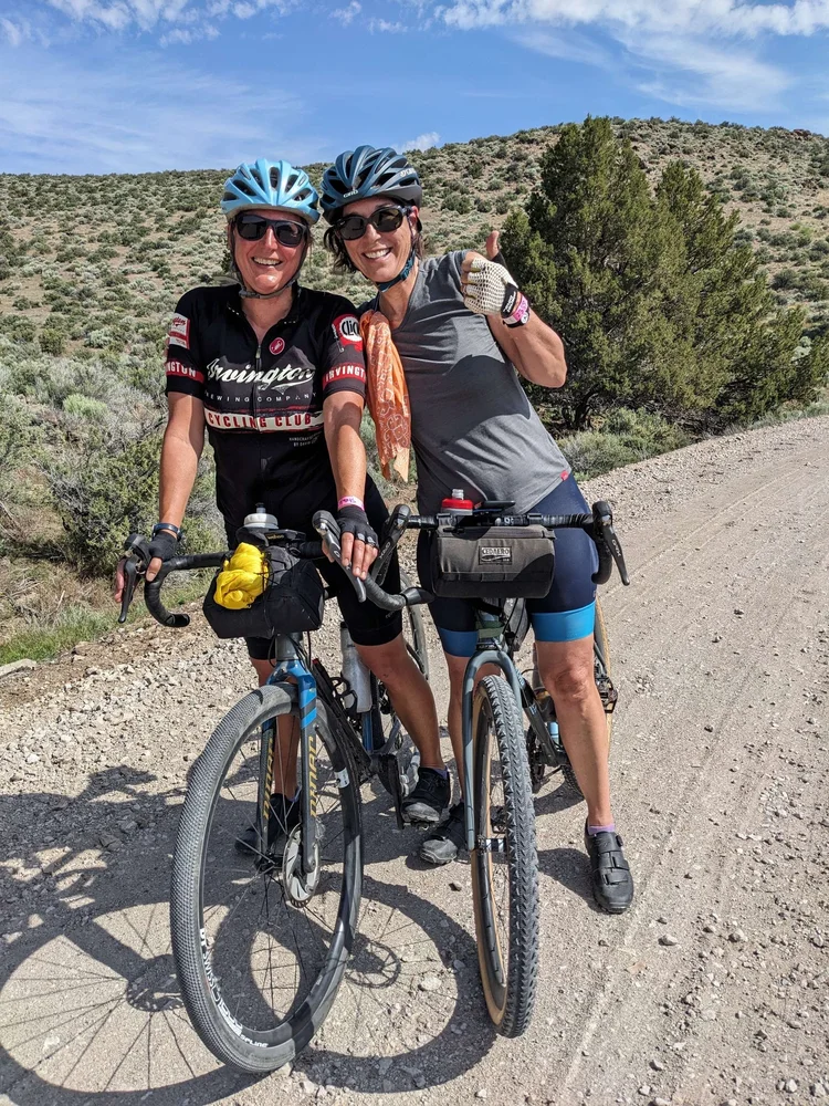 Two gravel cyclists pause on a high desert road in Lake County, Oregon
